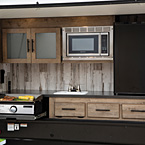 This optional outdoor kitchen has plenty of storage, both overhead and under the counter, 3.2 cu. ft. refrigerator, microwave, griddle, hot and cold running water, plus a handy USB wireless charging dock with expansion capabilities. (Select models)